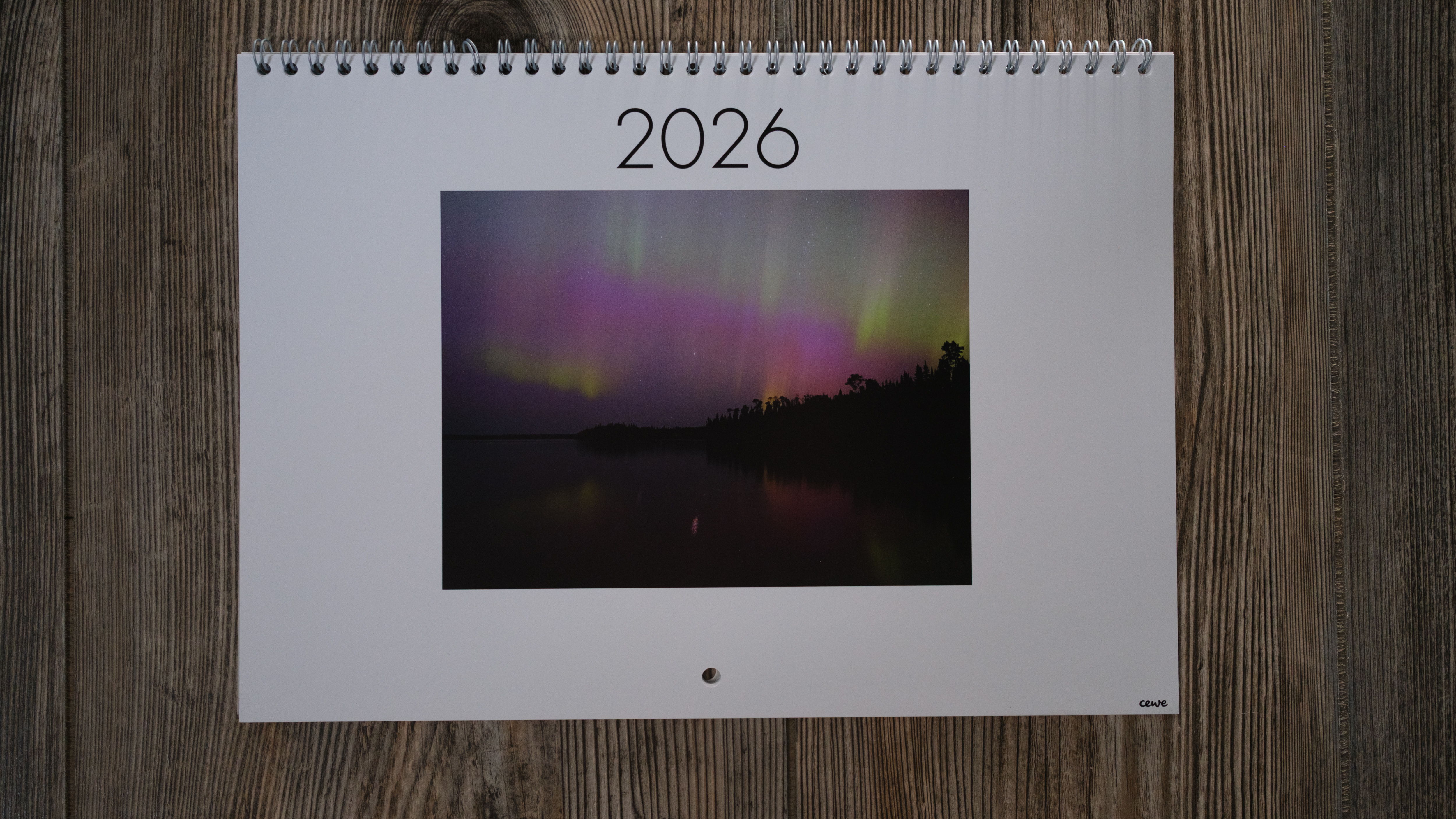 A photo calendar from CEWE on a wood background