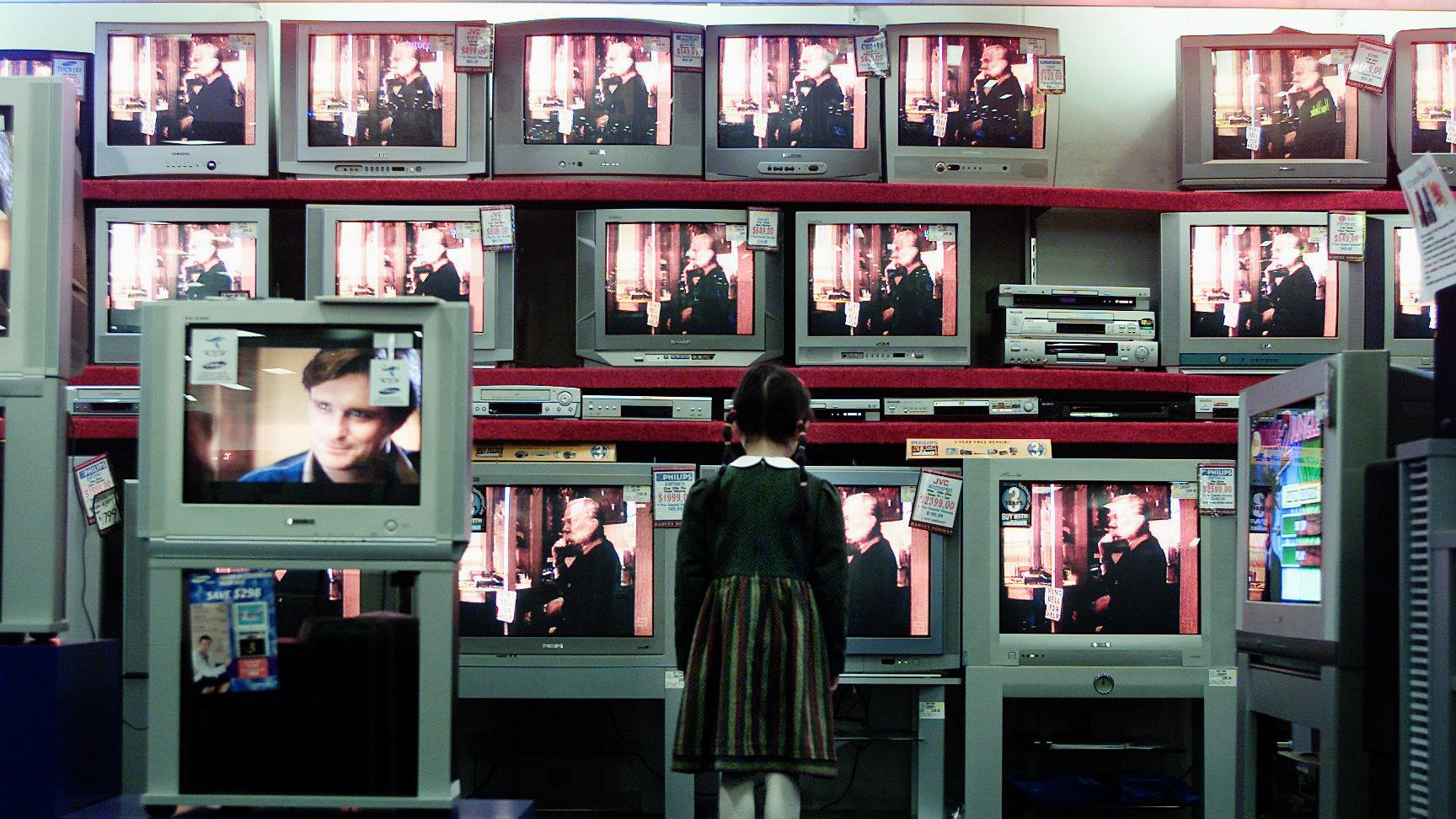 A girl looking at flat screen CRT televisions at Harvey Norman, 18 July 2005