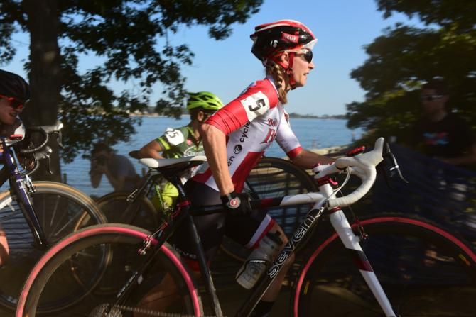 Mo Bruno Roy (Bobs Red Mill) carrying her bike up a short set of stairs