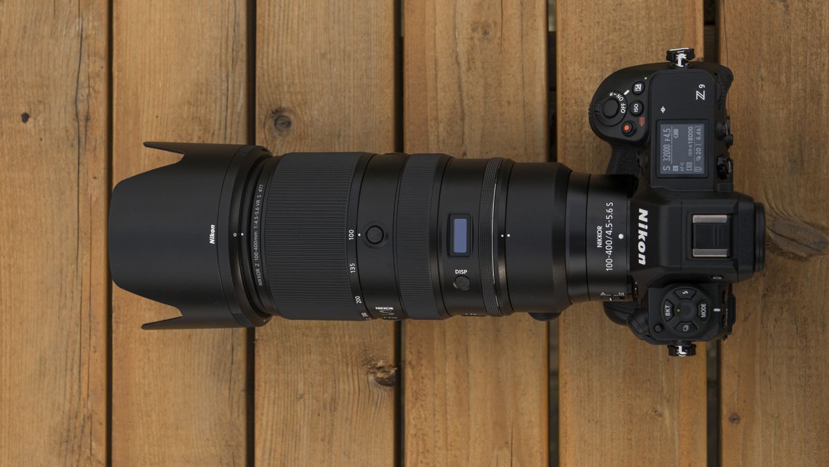 A Nikon Z telephoto lens on a wooden table