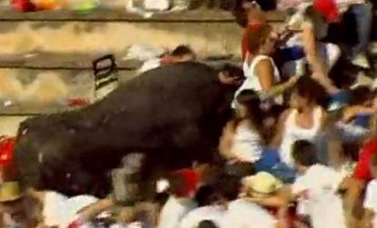 The bull jumped the barriers and charged the crowd. 