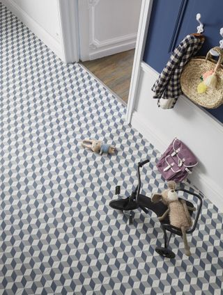 A blue geometric floor in a hallway