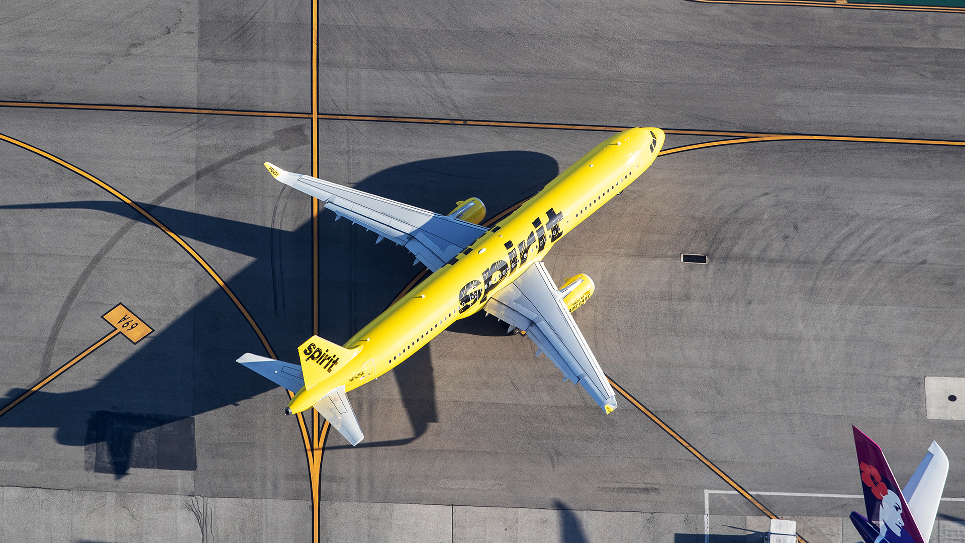 An overhead view of a Spirit Airlines Airbus A321 on the tarmac at Los Angeles International Airport (LAX) in the United States.