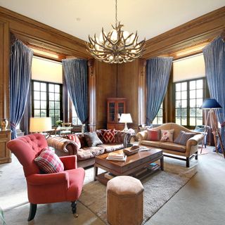 Drawing room with chandelier and sofa set with cushion