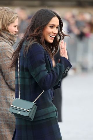 Meghan Markle carrying a Strathberry East / West Mini in Bottle Green