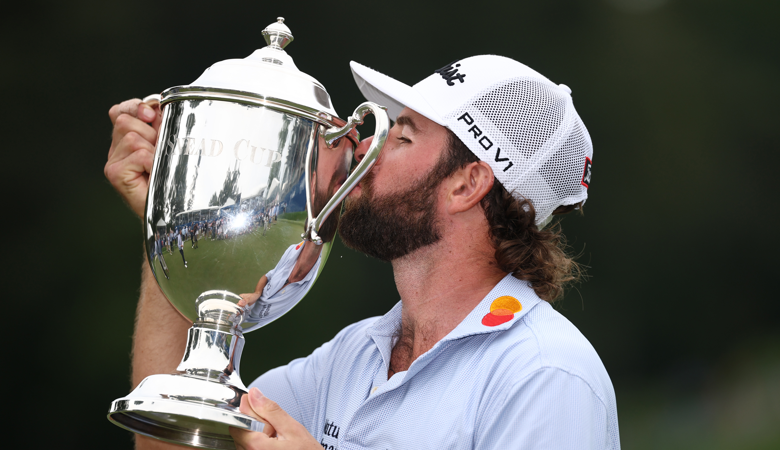 Cameron Young kisses the Wyndham Championship trophy