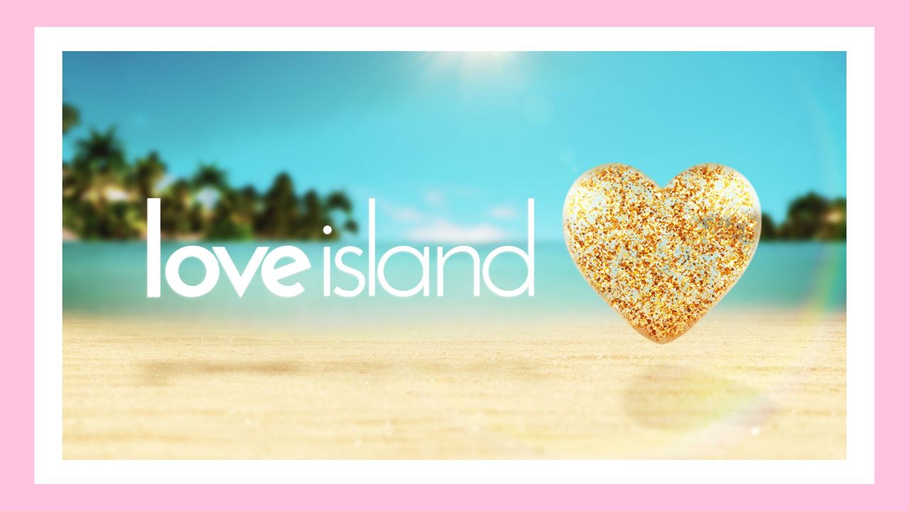 The Love Island logo depicting a heart and &#039;love Island&#039; name against a sandy beach backdrop - used for a piece on &#039;when does Love Island start?&#039;/ in a pink template