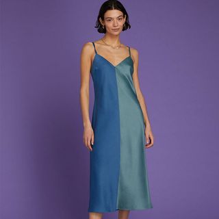 color block slip dress in two vertical blue shades an aqua hue and a more royal blue shown on a model