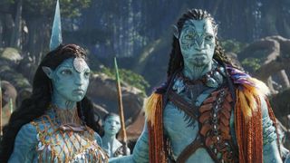 Upcoming sci-fi movies. Still from the movie Avatar: The Way of Water (2022). Here we see two tall blue pi-pedal creatures called Na'vi (female on the left, male on the right). They both have blue skin with dark blue stripes and long black hair. They have triable tattoos on their face and are wearing some ocean-themed garments. 