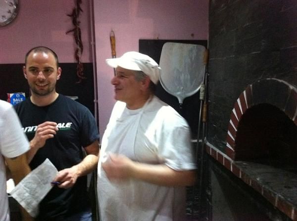 A pizzeria chef gives advice as Daniel Hespeller, Team Manager, coordinates the contest