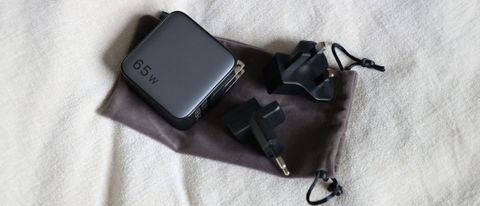 Ugreen Nexode 65W charger and adapters on a cloth surface