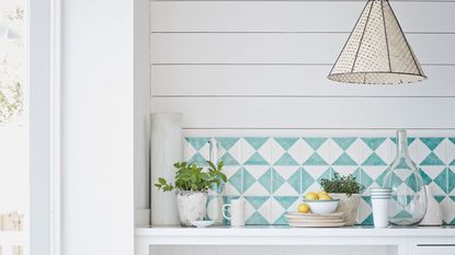 White kitchen with blue tiles and white crockery