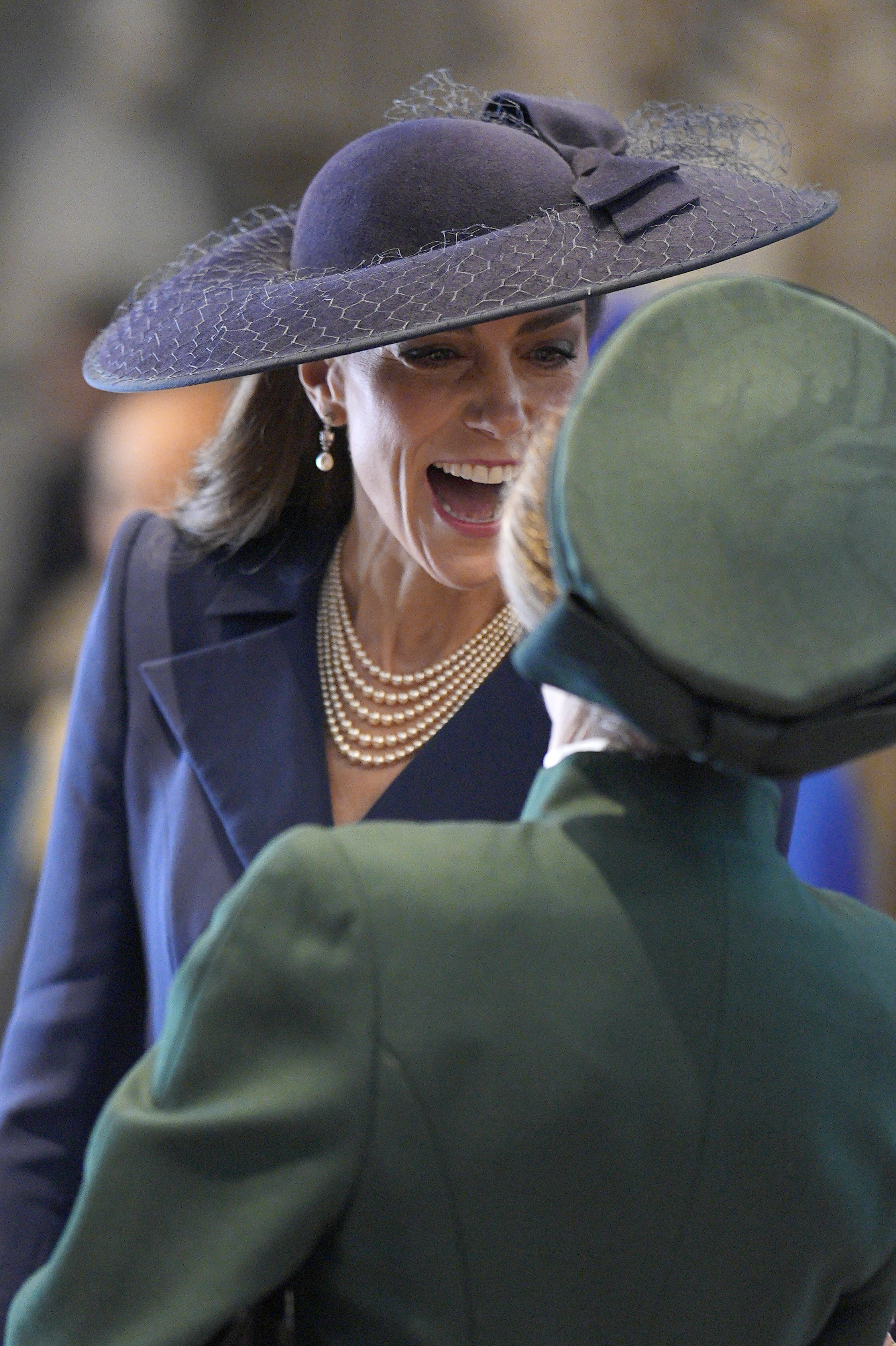 Kate Middleton wears a big blue hat and speaks with Princess Anne during the 2026 Commonwealth Day Service at Westminster Abbey on March 9, 2026 in London, England