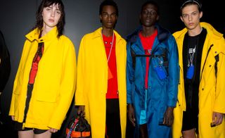 Neil Barrett S/S 2019 - Models wear bright yellow raincoats