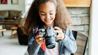 Child holding a DSLR