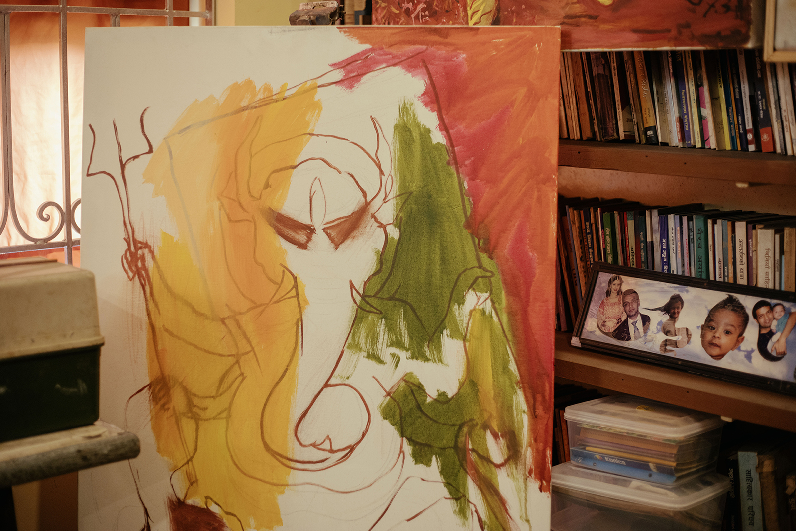 Manuj Babu Mishra&amp;rsquo;s studio, rich with full shelves, paintings, personal items and lots of colourful, lived-in decor