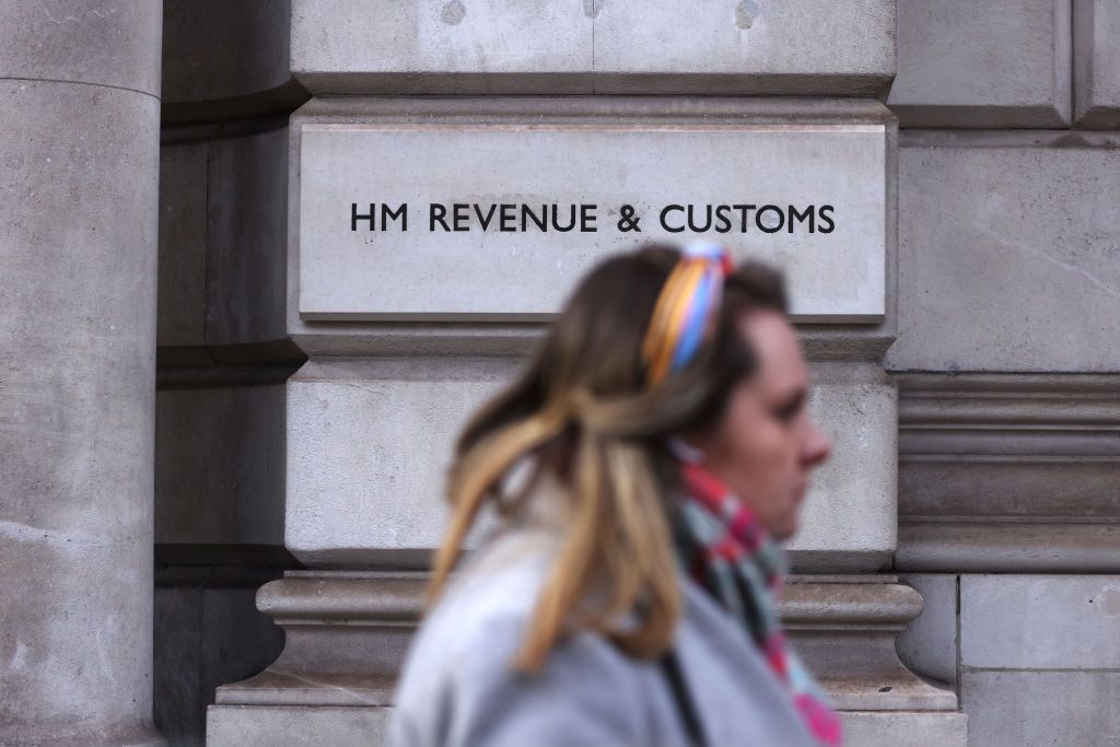 Woman walking past HMRC building