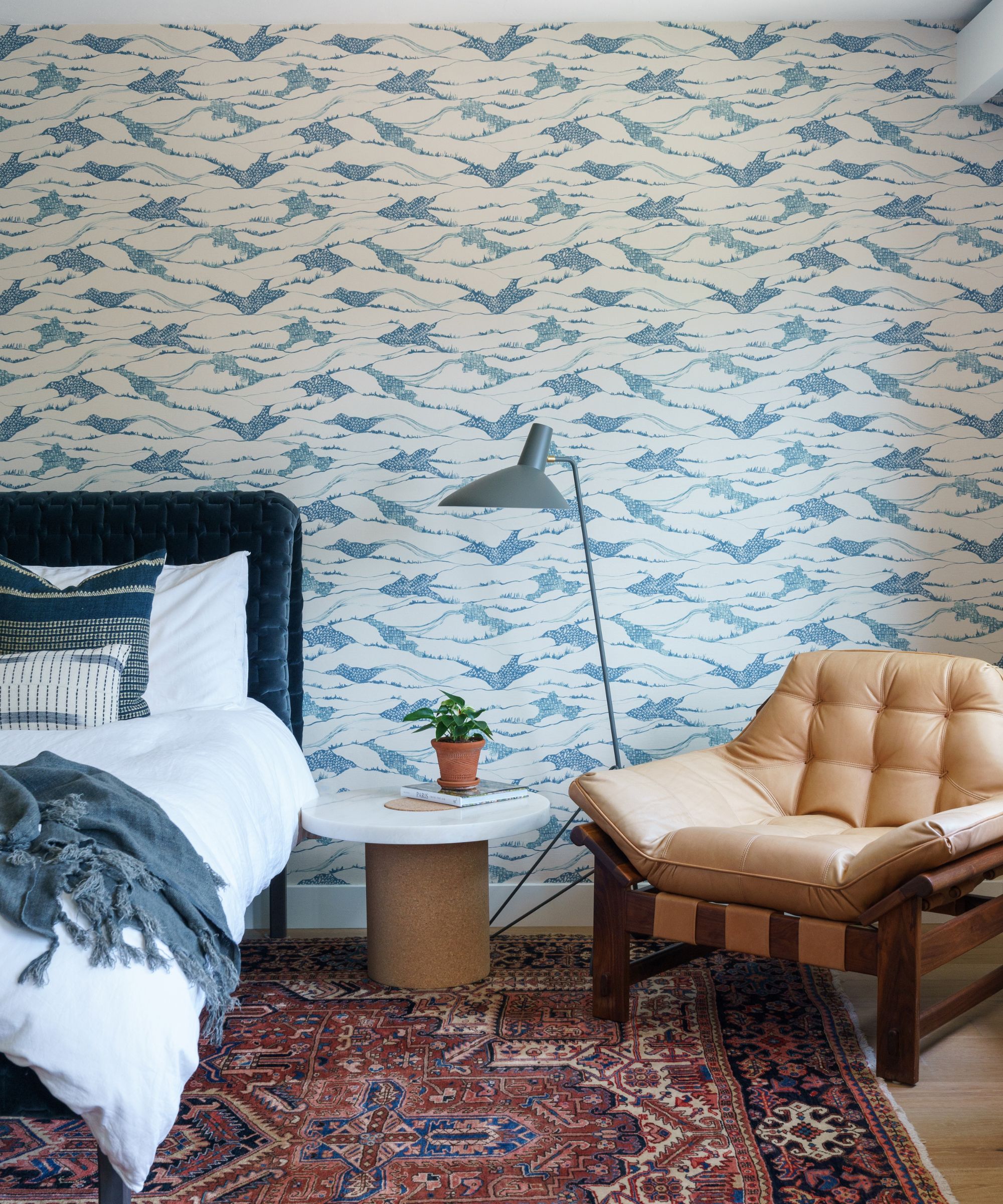 bedroom wallpaper with blue print and mid century vintage furnishings