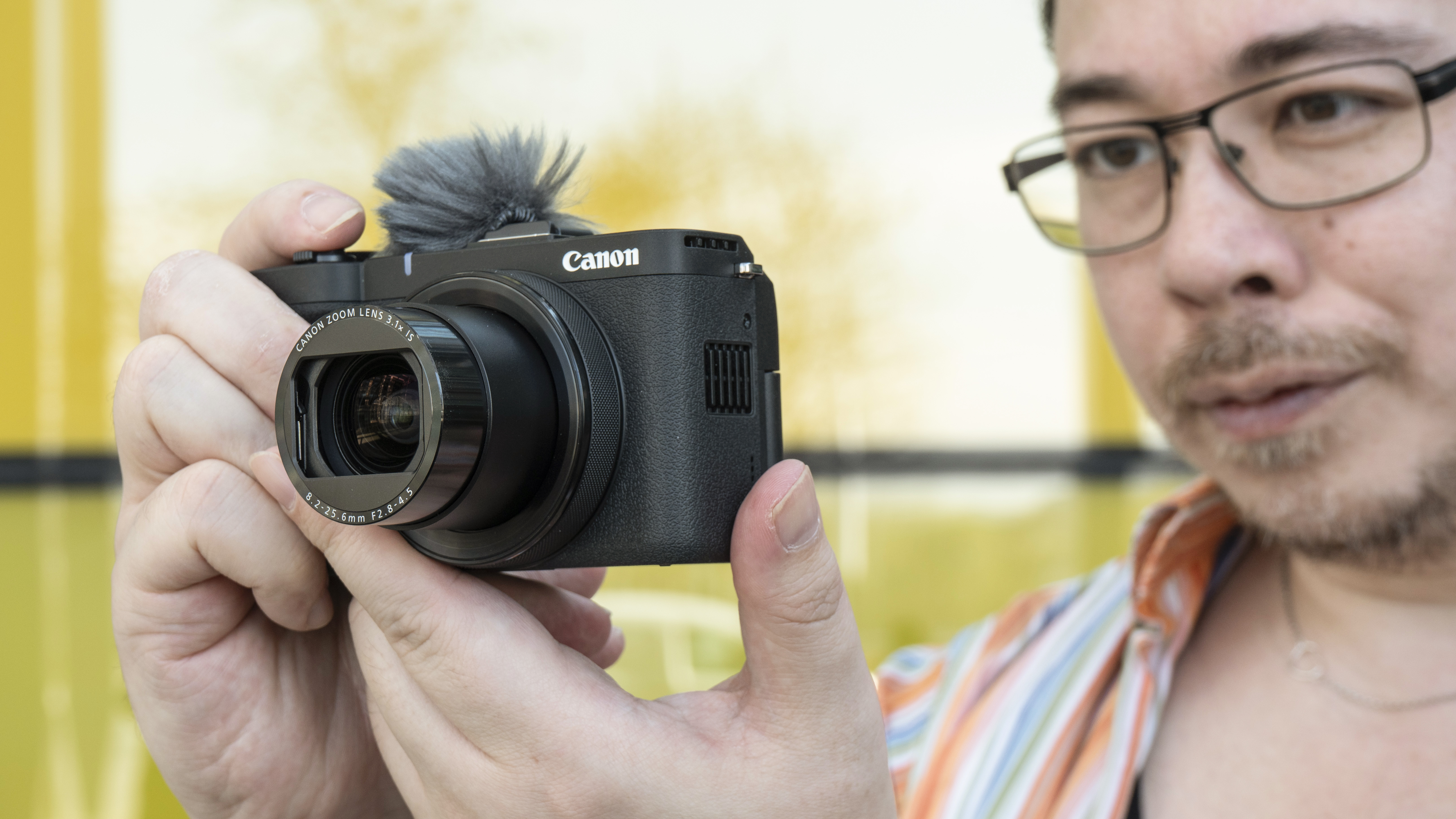 James Artaius holding a Canon PowerShot V1 camera