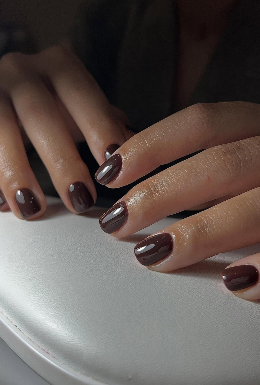 A close-up shot of dark brown nails