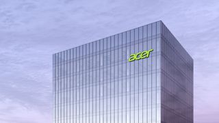 Acer logo on top of glass building with overcast sky in background
