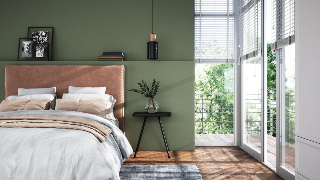 modern bedroom with green accent wall and balcony doors