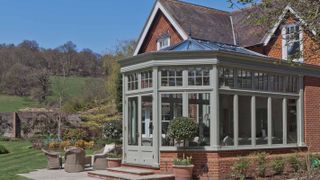 traditional timber orangery painted sage green