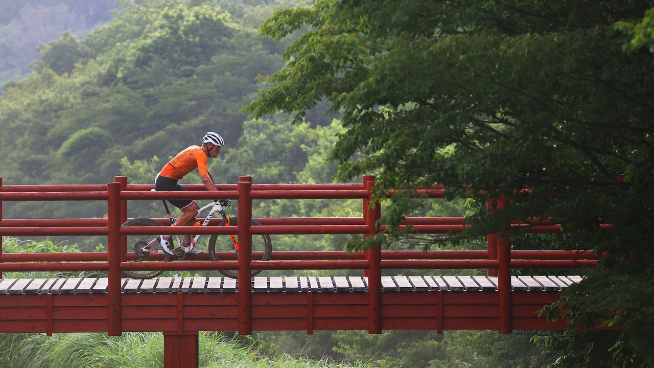 Mathieu van der Poel of Team Netherlands crosses a bridge on the circuit during the Men's Cross-country race on day three of the Tokyo 2020 Olympic Games at Izu Mountain Bike Course