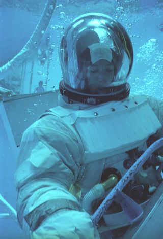 Astronaut Anna Fisher practices a Hubble Space Telescope servicing spacewalk underwater at the Neutral Buoyancy Simulator at NASA's Marshall Space Flight Center in Huntsville, Alabama in May 1980.