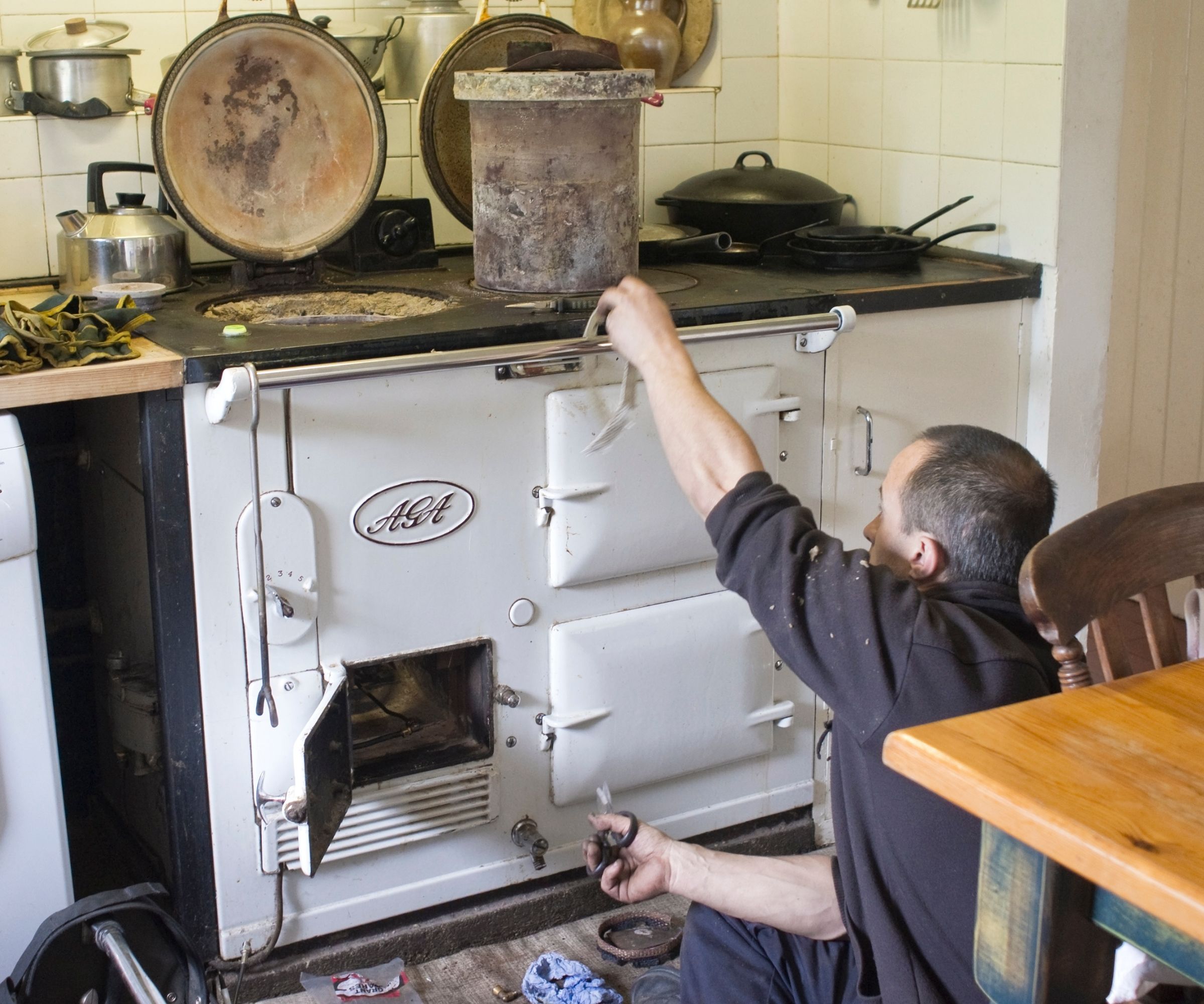 Engineer carrying out the twice yearly servicing of an old oil-fed cooker