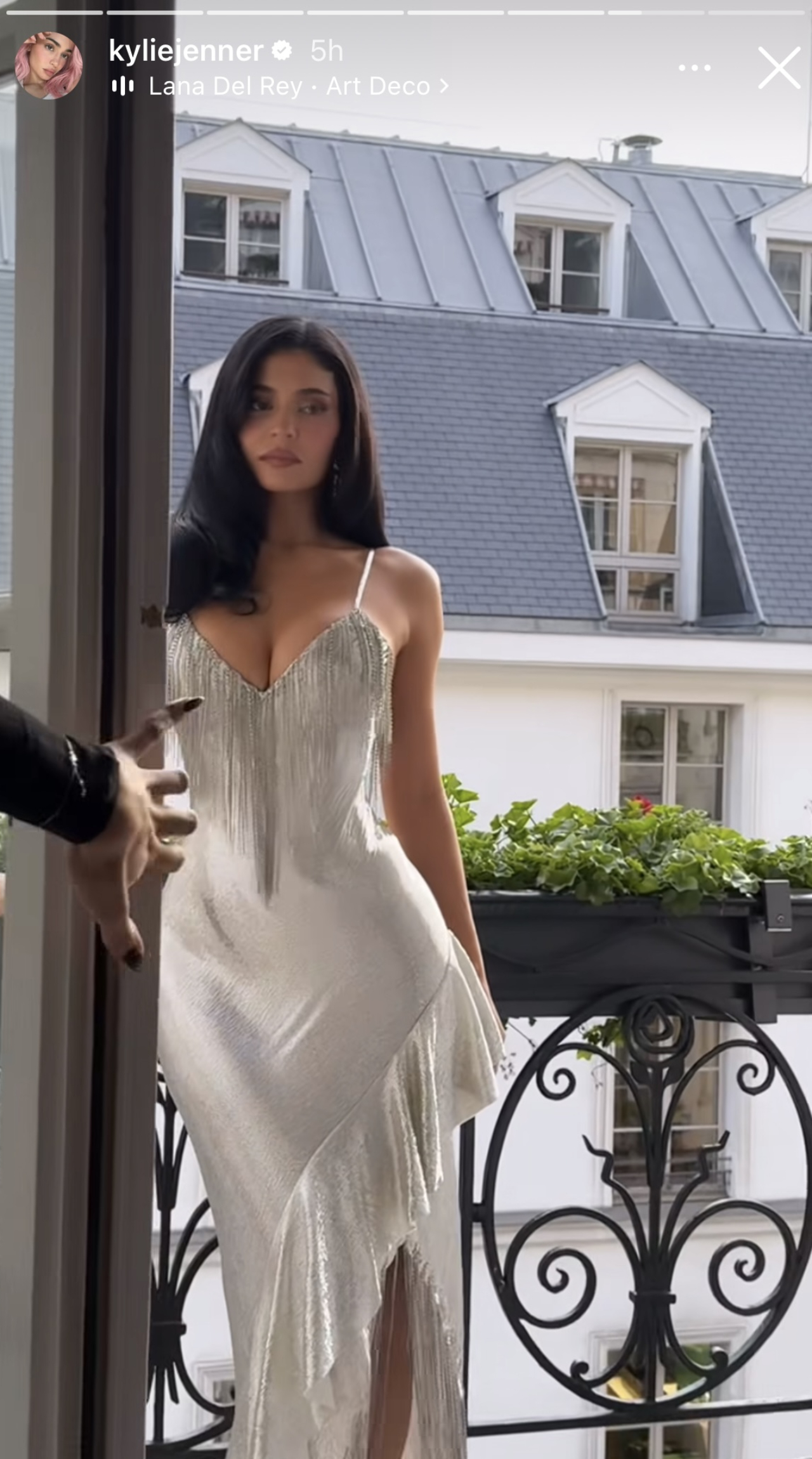 Kylie Jenner wearing a silver metallic dress.