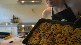 QTCinderella, a Twitch streamer, holds up a batch of cookies she made in under 4 minutes.