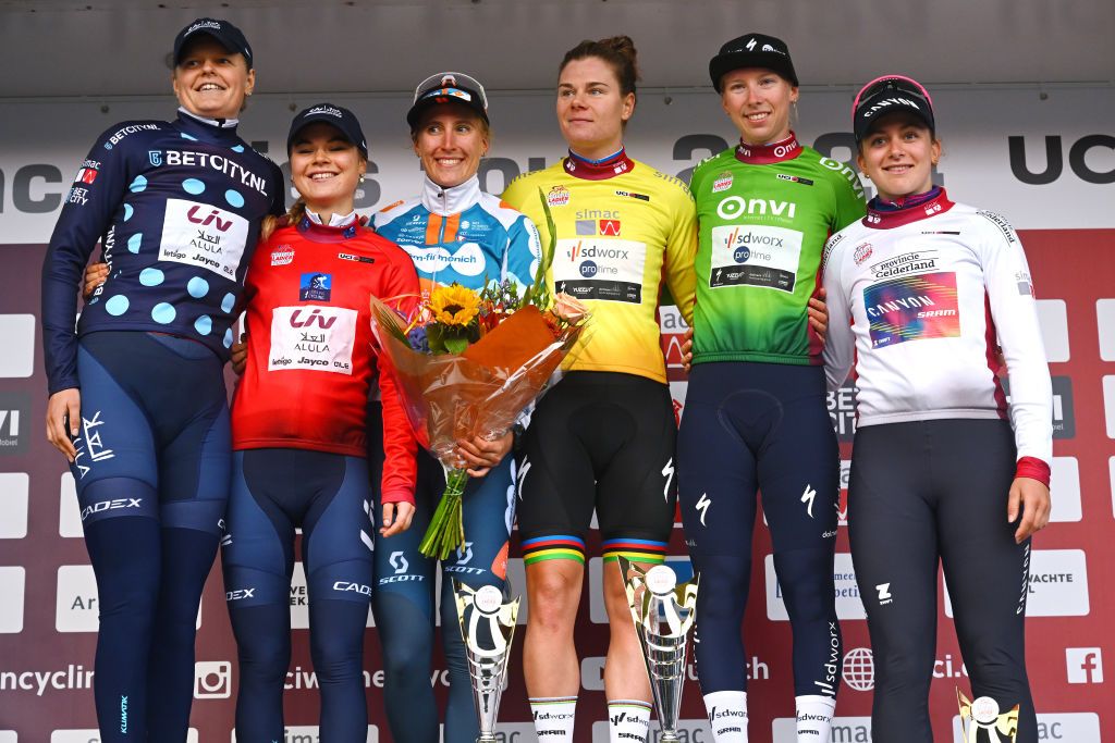 ARNHEM NETHERLANDS OCTOBER 13 LR Jeanne Korevaar of The Netherlands and Team Liv AlUla Jayco Polka Dot Mountain Jersey Silke Smulders of The Netherlands and Team Liv AlUla Jayco Red Most Combative Jersey Franziska Koch of Germany and Team dsmfirmenich PostNL Lotte Kopecky of Belgium and Team SD Worx Protime Yellow Leader Jersey Lorena Wiebes of The Netherlands and Team SD Worx Protime Green Points Jersey and Zoe Backstedt of The United Kingdom and Team CanyonSRAM Racing White Best Young Rider Jersey pose on the podium ceremony after the 26th Simac Ladies Tour 2024 Stage 6 a 1458km stage from Arnhem to Arnhem UCIWWT on October 13 2024 in Arnhem Netherlands Photo by Luc ClaessenGetty Images