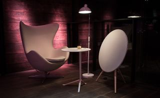 White 'egg chair' next to a white circle shaped floor lamp