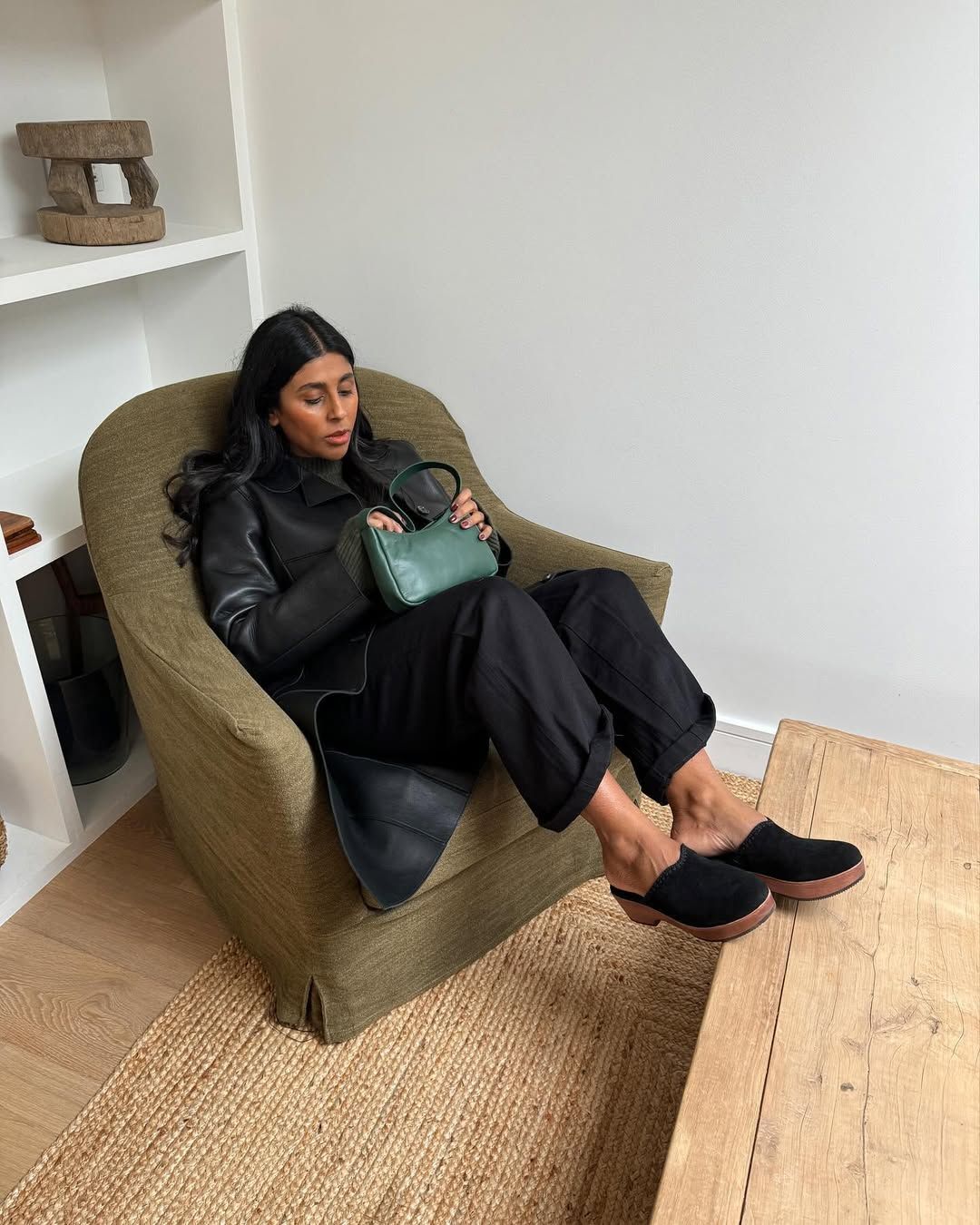 Monikh wearing black clogs and jeans