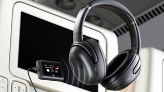 JBL Smart Tx Bluetooth gadget being used in a plane seat