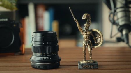 ZY Optics Pittura 30mm f/2.4 lens against a white background