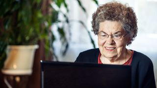 Happy senior women while working on laptop.
