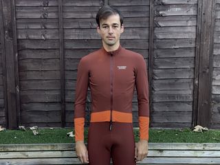 Male cyclist wearing the Pas Normal Studios Mechanism Thermal Jacket