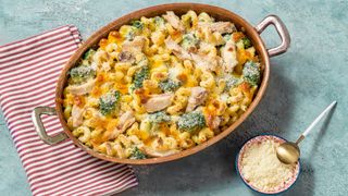 Baked broccoli and chicken pasta in baking dish on table