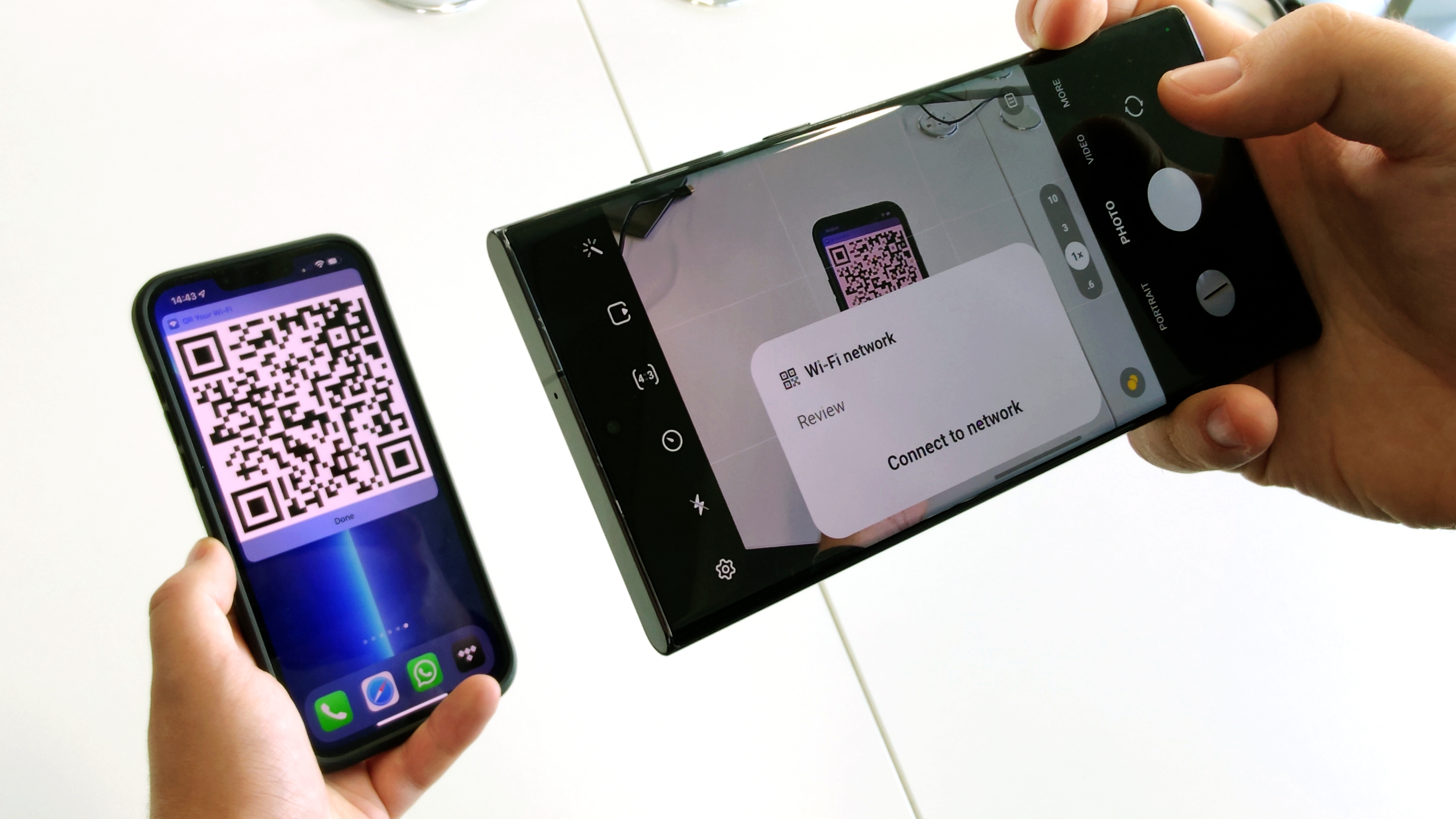 A Samsung Galaxy S22 Ultra scanning a Wi-Fi QR code from an iPhone 13 Pro Max, representing an article about how to share a wi-fi password from iPhone to Android