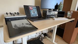 An image of the VonHaus Standing Desk with multiple different gadgets on it
