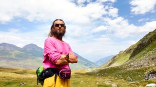 Man hiking the Swiss Alps in Summer