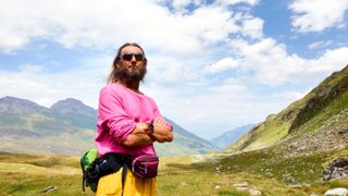 Man hiking the Swiss Alps in summer