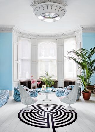 Blue and white living room with monochrome rug