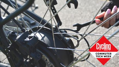 Female cyclist maintaining an electric bike