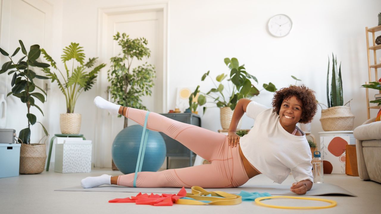 Woman doing side leg raises with a resistance band