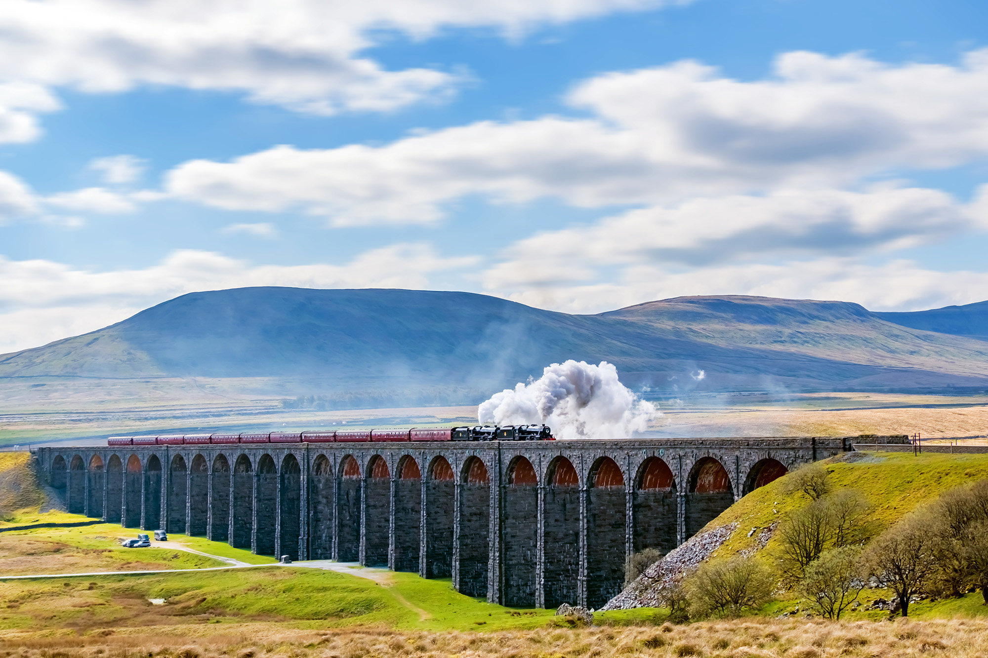 Steam train crossing the Ribblehead Viaduct, Yorkshire Dales, England, UK
