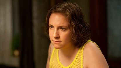 Lena Dunham in a yellow string vest.