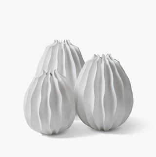 Three white vases of different sizes (small, medium and large). The vases have narrow openings at the top.
